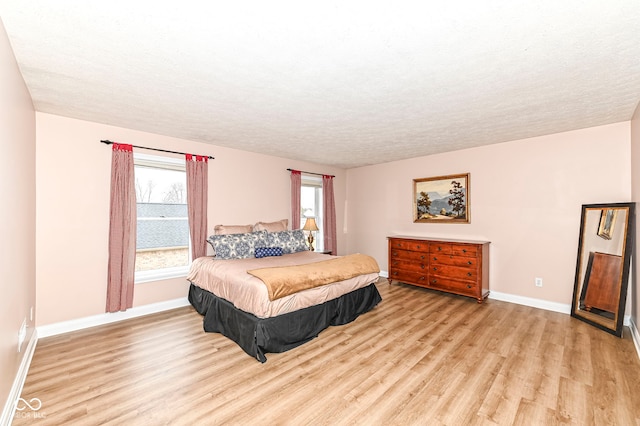 14626 Warner Trl, Westfield, IN 46074 - bedroom with wood finished floors, a textured ceiling, and baseboards