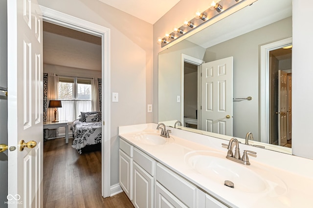 14626 Warner Trl, Westfield, IN 46074 - bathroom featuring double vanity, wood finished floors, and ensuite bathroom