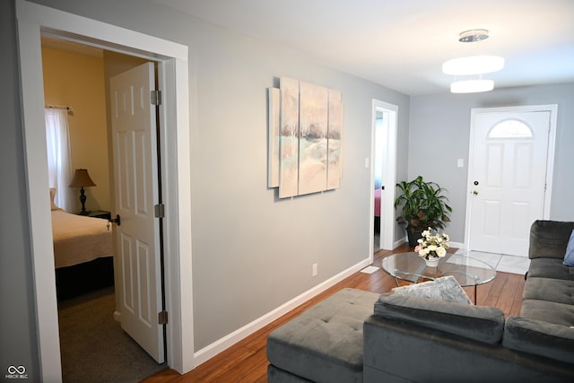 living room with baseboards and wood finished floors