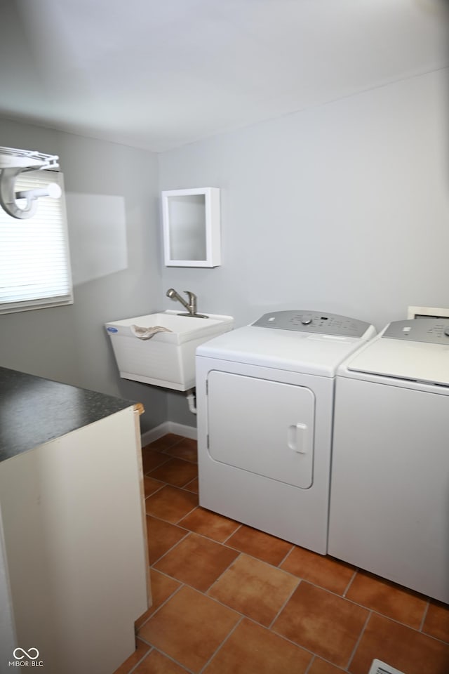 washroom with washer and dryer, laundry area, a sink, and light tile patterned floors