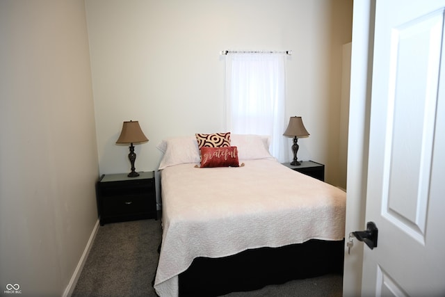 bedroom featuring baseboards and dark colored carpet