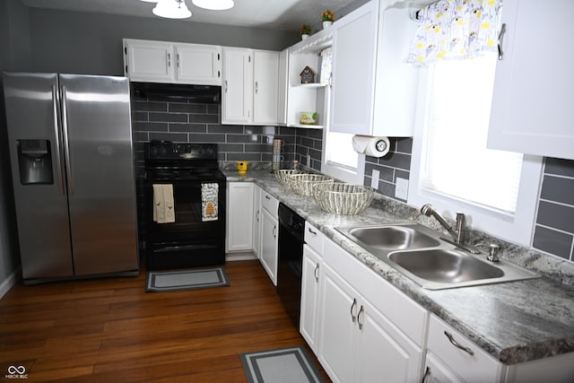 kitchen with under cabinet range hood, dark wood-style flooring, a sink, white cabinetry, and black appliances