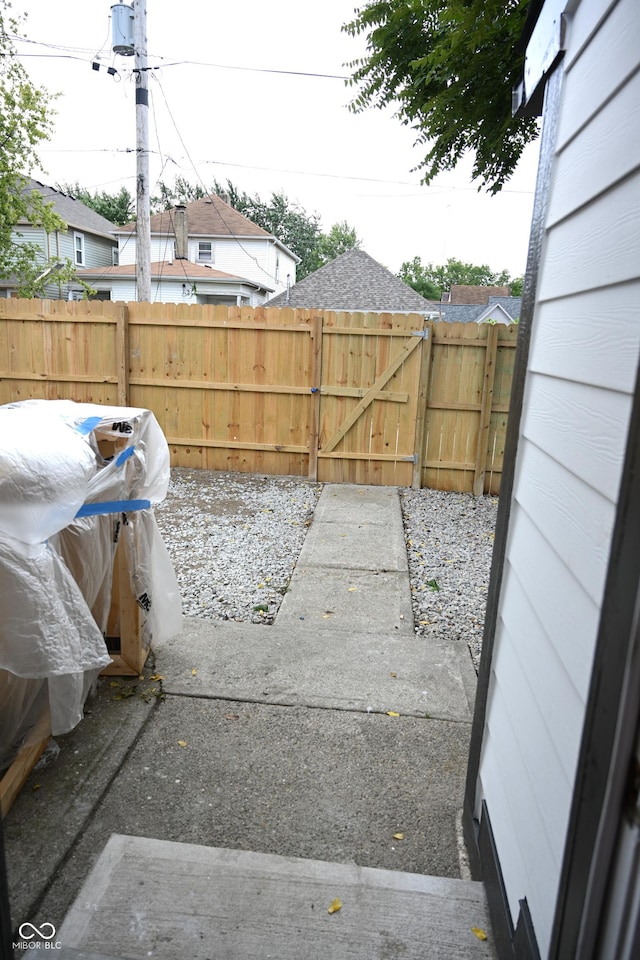 view of yard with a gate, a patio area, and fence