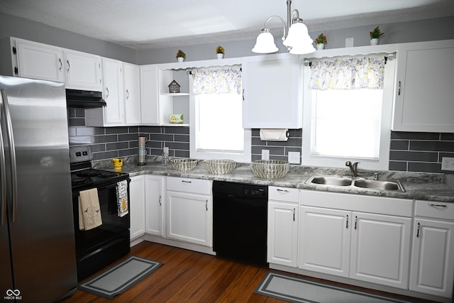 kitchen featuring decorative light fixtures, white cabinetry, a sink, under cabinet range hood, and black appliances