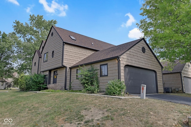 view of side of home featuring cooling unit, a yard, and a garage