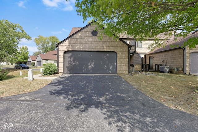 view of front facade featuring a garage and central AC