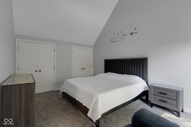 bedroom with high vaulted ceiling, two closets, and carpet flooring