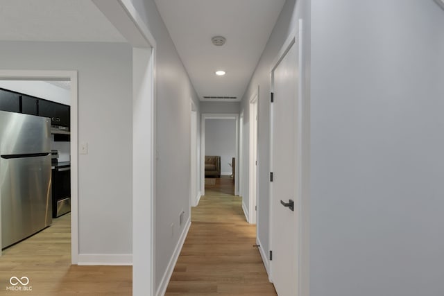 hallway with light hardwood / wood-style flooring