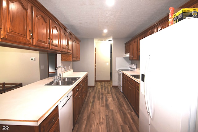 kitchen with a textured ceiling, white appliances, dark wood-type flooring, and sink