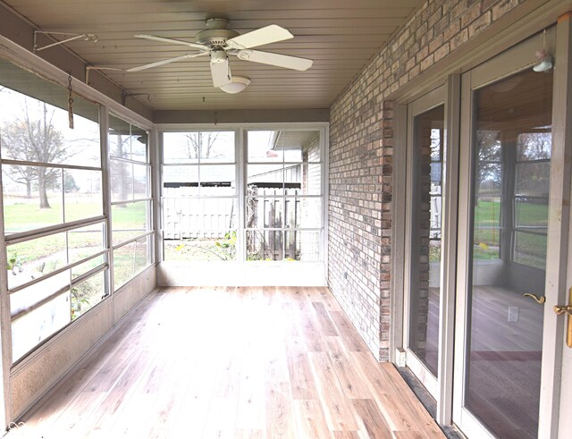 unfurnished sunroom featuring ceiling fan and wood ceiling