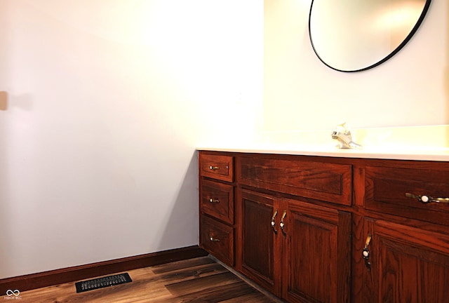 bathroom with vanity and hardwood / wood-style flooring