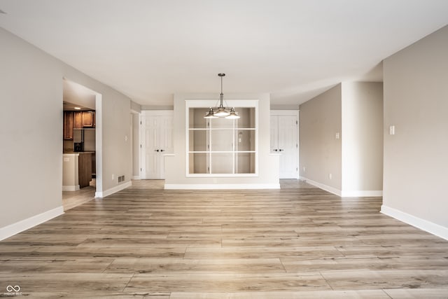 unfurnished living room featuring light wood-type flooring