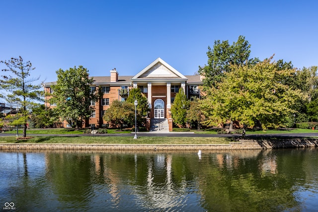 exterior space with a water view and a front yard