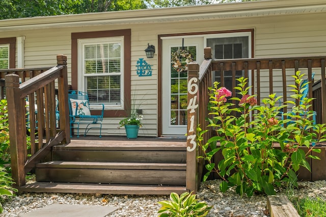 property entrance with a wooden deck