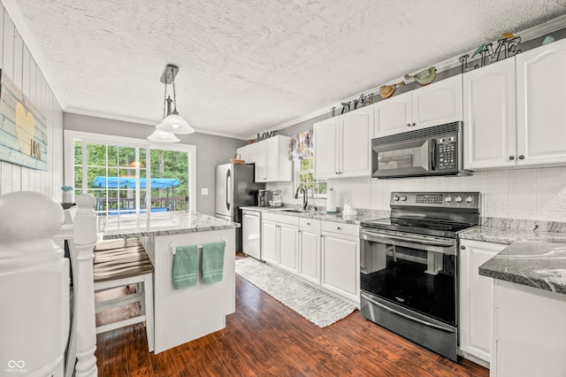 kitchen with appliances with stainless steel finishes, dark wood-type flooring, and white cabinets