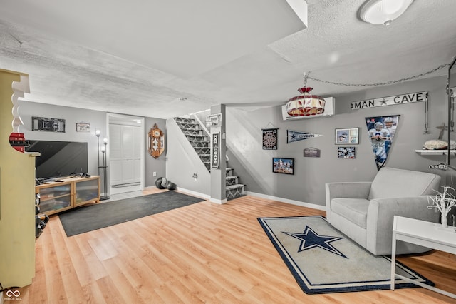 living room featuring a textured ceiling and hardwood / wood-style flooring