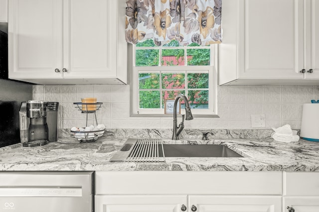 kitchen with sink, white cabinets, backsplash, and dishwashing machine