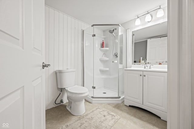 bathroom with tile patterned flooring, vanity, walk in shower, and toilet