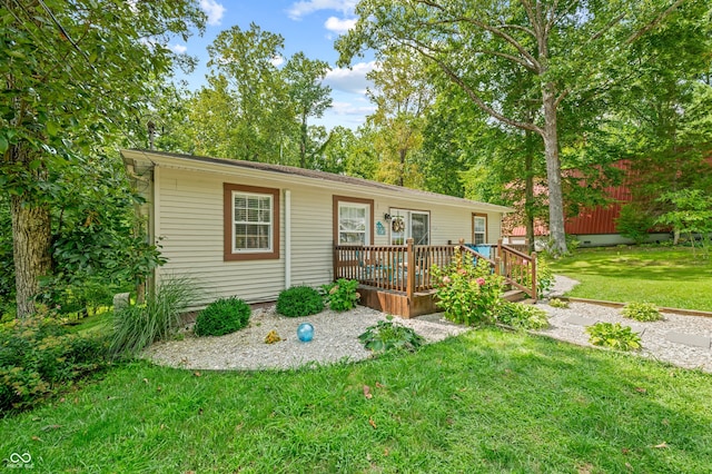 view of front of house featuring a deck and a front lawn