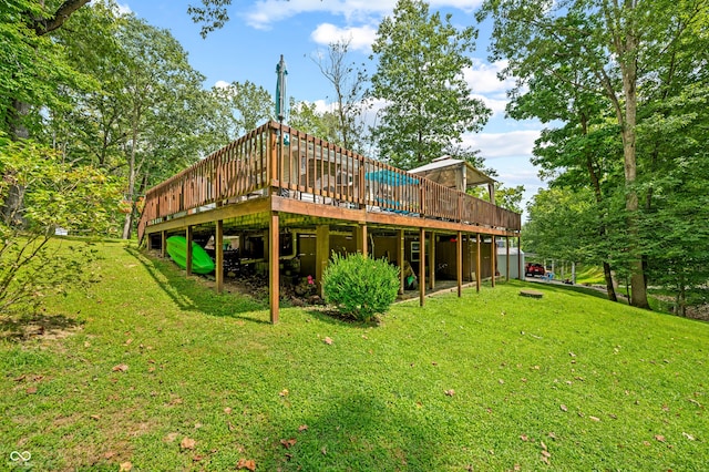 back of property with a wooden deck and a yard