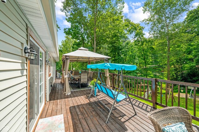 wooden terrace featuring a gazebo