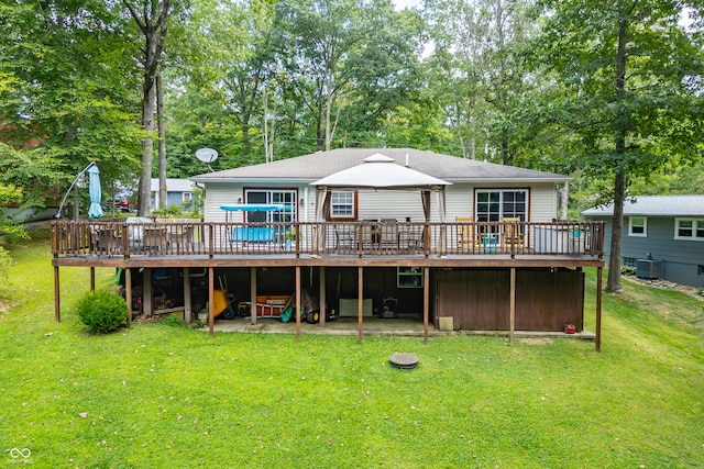 back of house with a deck and a lawn