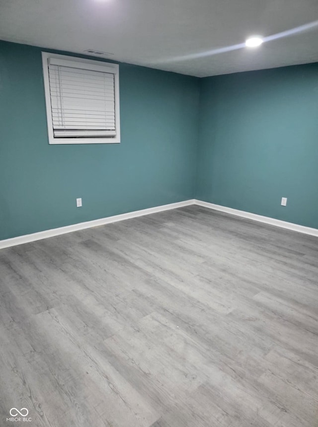 spare room featuring wood-type flooring