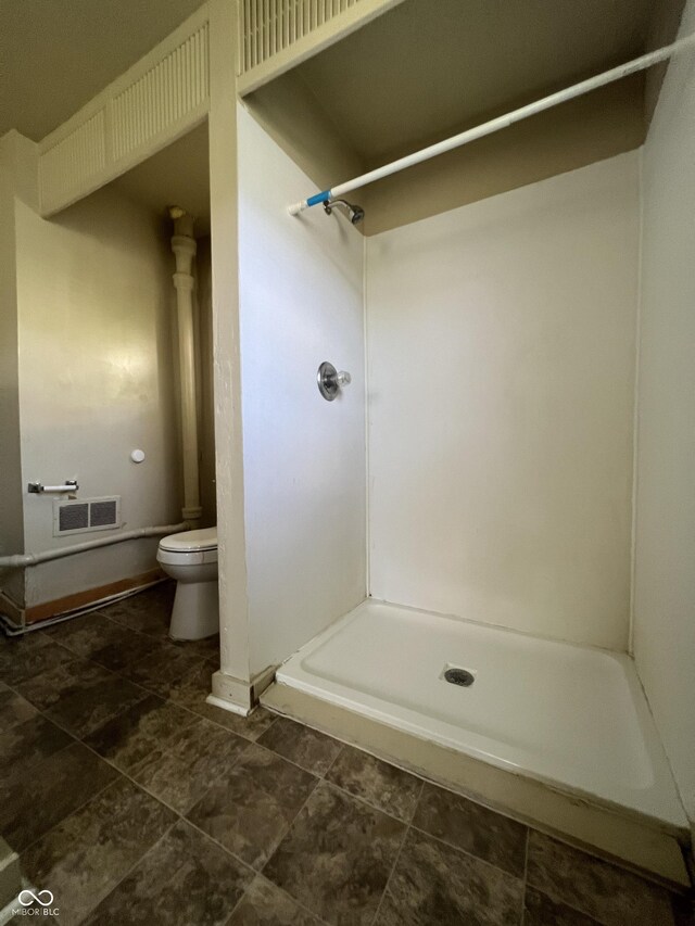 bathroom with toilet and walk in shower