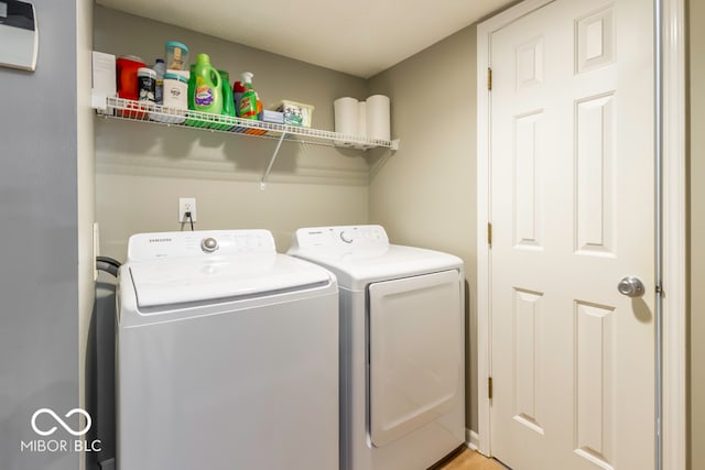 clothes washing area with independent washer and dryer