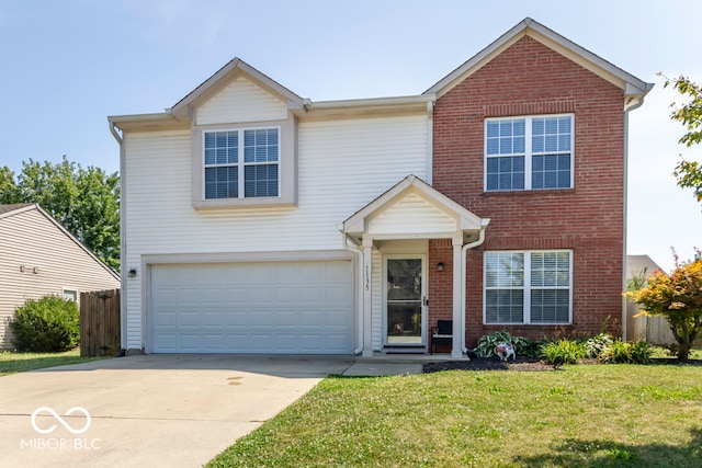 view of property featuring a garage and a front yard