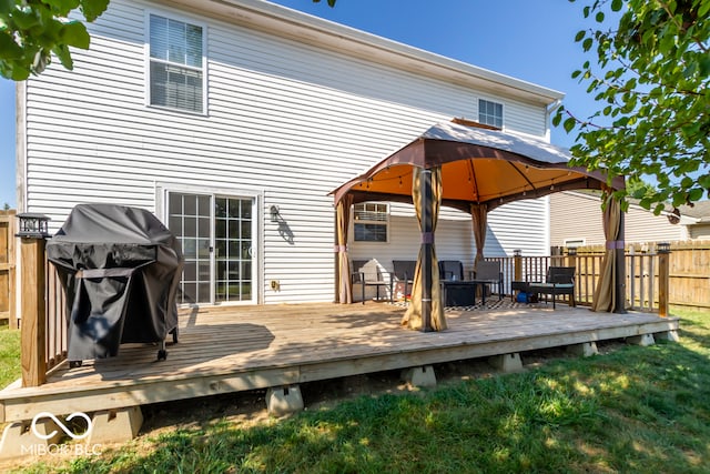 back of house featuring a deck and a gazebo