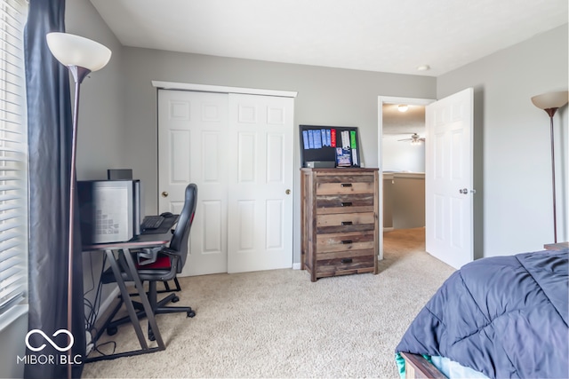 bedroom featuring light colored carpet and a closet