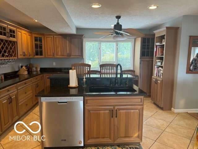 kitchen featuring dishwasher, ceiling fan, sink, and a kitchen island