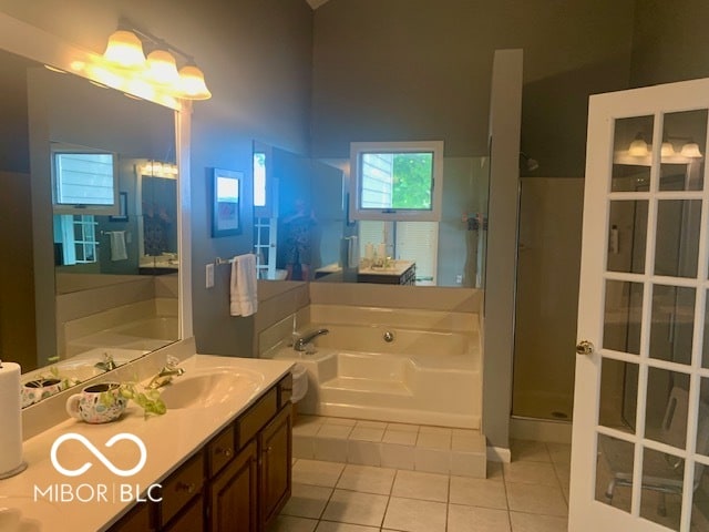 bathroom featuring tile patterned flooring, separate shower and tub, and vanity