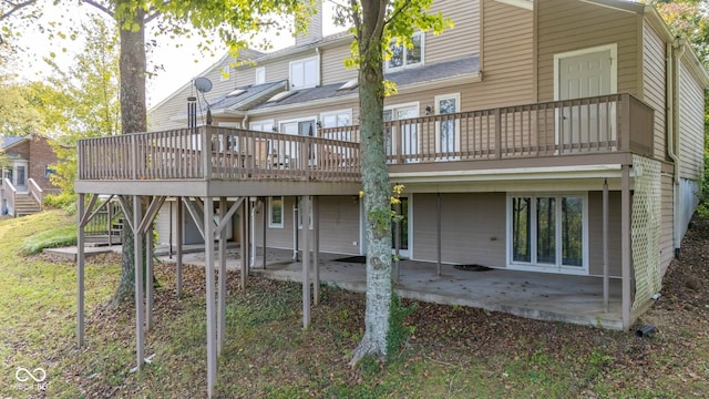 rear view of property with a wooden deck and a patio