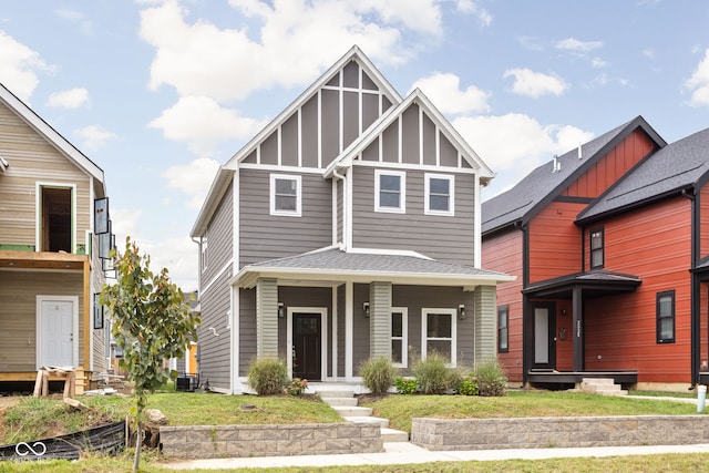 view of front of property with a porch and a front lawn