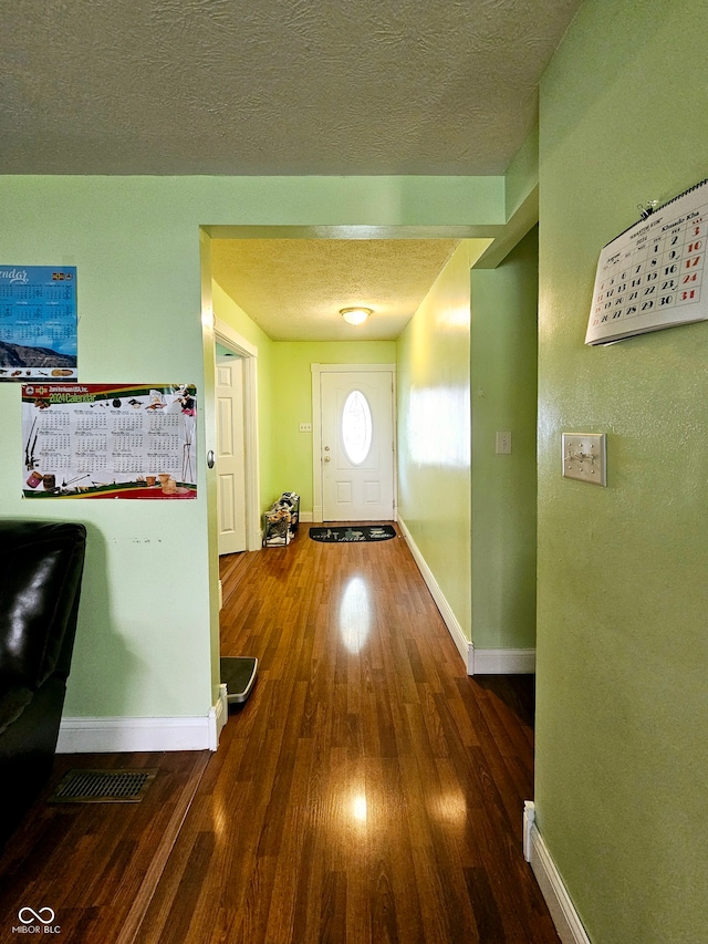 corridor featuring hardwood / wood-style flooring and a textured ceiling