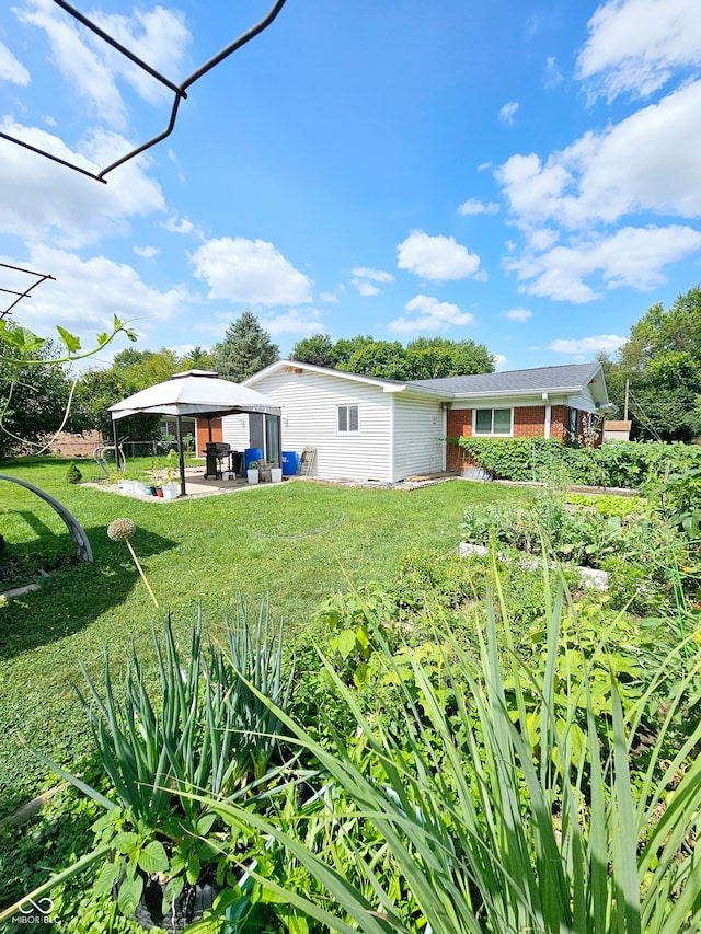 view of yard with a patio, an outdoor hangout area, and a gazebo