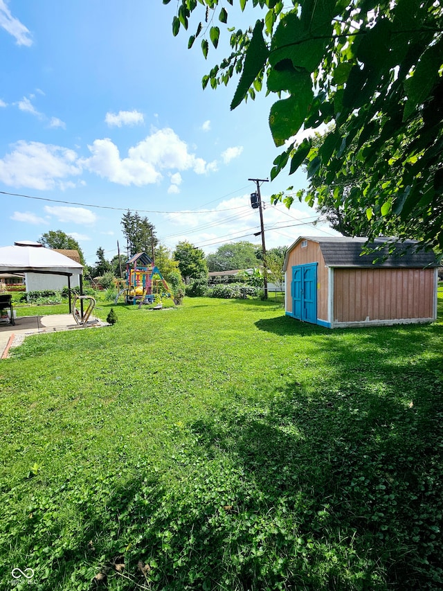 view of yard featuring a storage shed and a playground