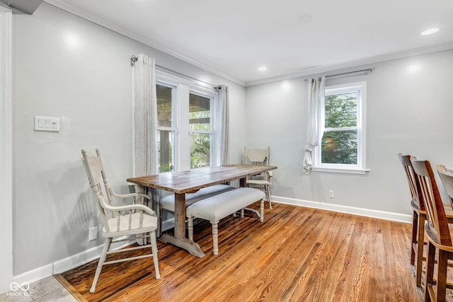 dining room featuring ornamental molding and hardwood / wood-style flooring