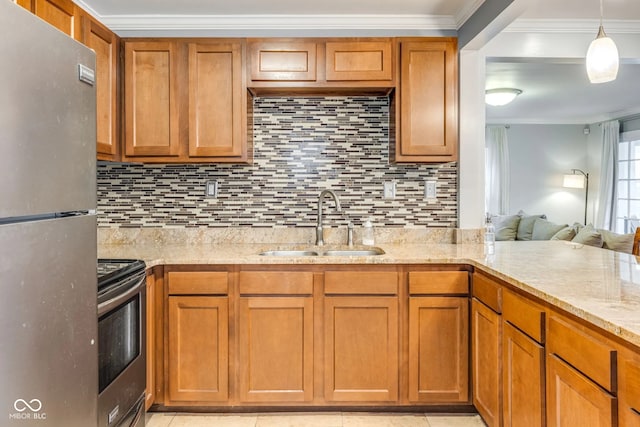 kitchen with appliances with stainless steel finishes, tasteful backsplash, sink, and light stone countertops