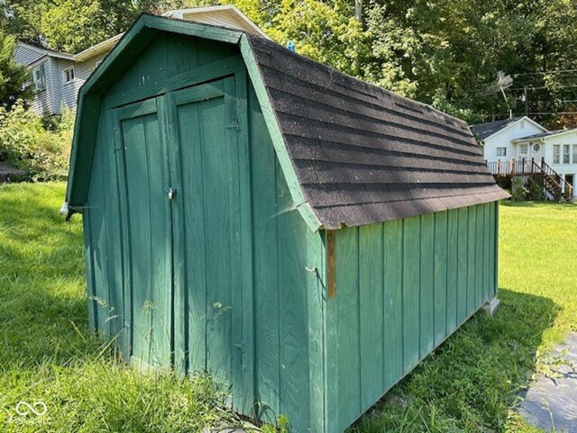 view of outbuilding featuring a lawn