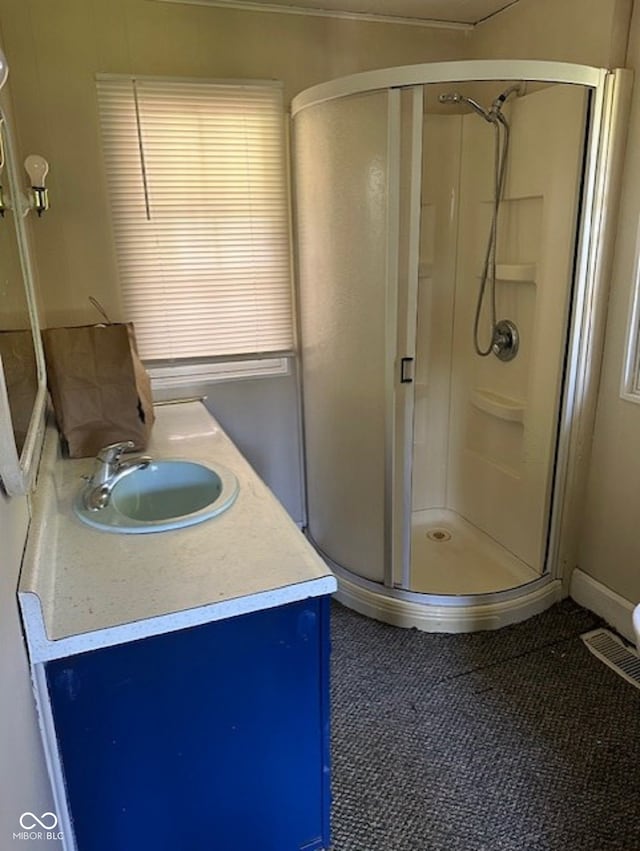 bathroom with an enclosed shower and vanity