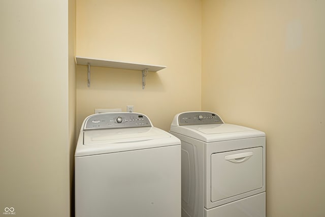 clothes washing area featuring washer and dryer