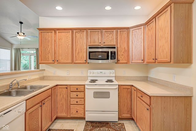 kitchen with light tile patterned floors, white appliances, sink, and ceiling fan