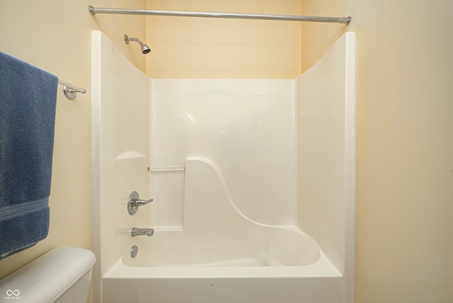 bathroom with toilet and  shower combination