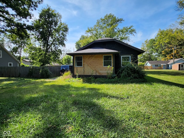 view of side of property with a lawn