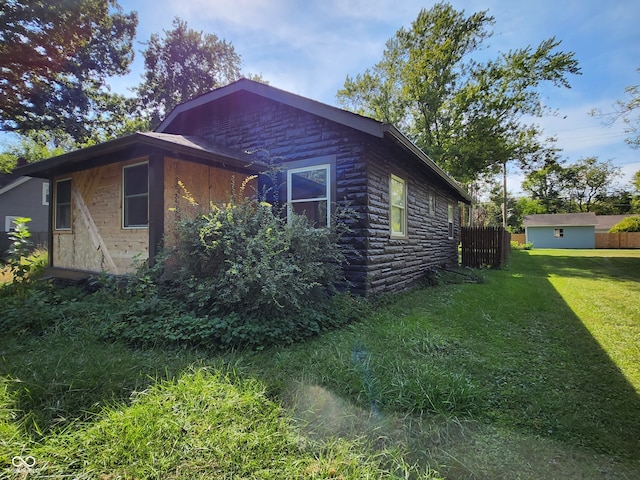 view of property exterior with a yard