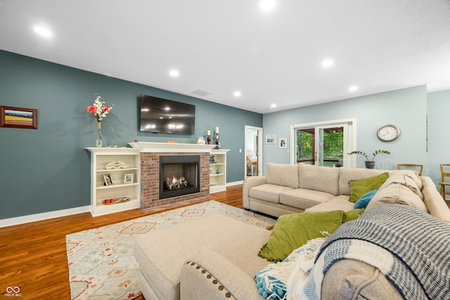 living room featuring hardwood / wood-style floors and a fireplace