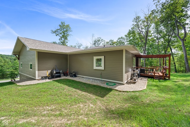 back of property featuring a lawn and a deck